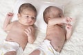 One month newborn twin babies with diaper resting on white blanket Royalty Free Stock Photo