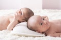 One month newborn twin babies resting on bed Royalty Free Stock Photo