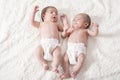 One month newborn twin babies resting on white blanket Royalty Free Stock Photo