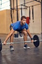 One more. Full length shot of a handsome young man lifting weights while working out in the gym. Royalty Free Stock Photo