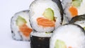 One or more maki rolls in a row with salmon, avocado, tuna and cucumber isolated on white background. Fresh hosomaki pieces with r Royalty Free Stock Photo