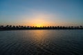 One more perfect sunset. Sunset on sea coast with palm trees and sun reflection water. Silhouette of palm trees tropical Royalty Free Stock Photo