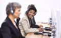 One more sale in the bag. three female call center representatives wearing headsets. Royalty Free Stock Photo