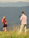 One more shot. Travel together with darling. Couple taking photo. Couple in love hiking mountains. Lets take photo Royalty Free Stock Photo