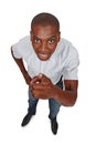 One more thing. High angle studio shot of a young man pointing toward the viewer. Royalty Free Stock Photo