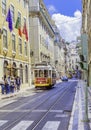 View of One of the most famous and historical electric tram of No. 28 running on the fancy street. Lisbon, Portugal Royalty Free Stock Photo