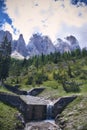 Waterfalls and a beauty background of Tre cime di Lavaredo, at Dolomites