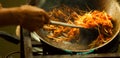 One of the most favorite and famous Asian Thai street fast food in hot pan, Pad Thai, is a stir fried rice noodle dish