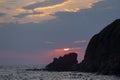 After rise, the sun clothed in the clouds above the rock. View from Sinemorets resort, Southern Black Sea Coast, Bulgaria. Royalty Free Stock Photo