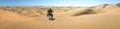 One Motorbiker driving in sand dune desert. Motorcycle Adventure in Namib Desert, Namibia.