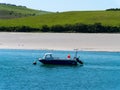 One motorboat is anchored near the picturesque shores of southern Ireland. Seaside landscape. Royalty Free Stock Photo