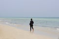 One Muslim woman is walking along the beach Royalty Free Stock Photo