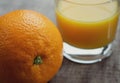 One navel orange fruit with a glass of fresh orange juice