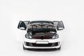 one new white car with open doors and open hood Royalty Free Stock Photo