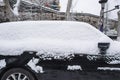 A small car covered with snow on the edge of the ancient city wall Royalty Free Stock Photo