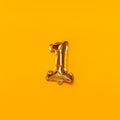 One number gold balloon on a yellow background