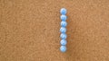 One, number made by pastel blue pushpin on cork board texture