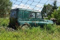 One old abandoned green Soviet car in the grass Royalty Free Stock Photo