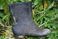 One old black wet dirty rubber boot Royalty Free Stock Photo