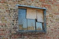 Old Broken Window With A Lattice On A Brick Brown Wall