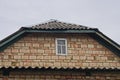 One old brown brick loft with a small gray wooden window Royalty Free Stock Photo