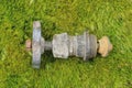 one old brown gray iron piece of plumbing with a valve and part of a threaded pipe