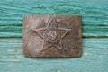 One old brown metal large Soviet belt buckle with a star Royalty Free Stock Photo