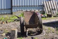 one old brown rusty metal empty garden wheelbarrow Royalty Free Stock Photo