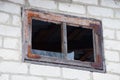 One brown window with broken glass on a gray brick wall Royalty Free Stock Photo