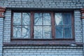 One old brown window on a gray brick wall Royalty Free Stock Photo