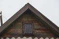 One old brown wooden loft of a rural house with a small window Royalty Free Stock Photo