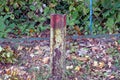 One old colored iron boundary post covered with brown rust Royalty Free Stock Photo