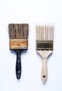 One old dirty paintbrush side by side with new clean paintbrush