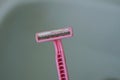 One old dirty pink plastic razor Royalty Free Stock Photo