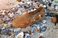 One old and dirty rubber shoe on the beach . Royalty Free Stock Photo