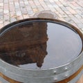 One old-fashioned wooden barrel on the pavement, after the rain