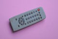 One old gray dirty plastic television remote control with buttons