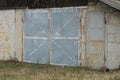 One old gray metal garage with closed gate Royalty Free Stock Photo