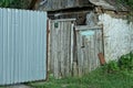 One old gray wooden rural door on a metal fence Royalty Free Stock Photo