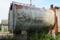 One old iron gray tank in brown rust