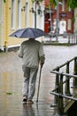 One old man with umbrella and cane Orebro Sweden august 9 2023