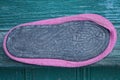 One old pink slipper made of fabric with a black rubber sole Royalty Free Stock Photo