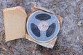 one old plastic magnetic reel for a tape recorder lies in a brown paper package Royalty Free Stock Photo