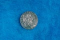 Old rarity silver coin on blue woolen cloth