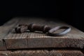 one old rusty key lies on old wooden board against a dark background Royalty Free Stock Photo