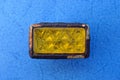 One old rusty rectangular reflector with yellow glass