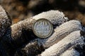 Old silver soviet coin on fingers in glove