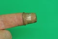 One old small steel thimble on finger Royalty Free Stock Photo