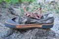 one old torn gray brown sneaker Royalty Free Stock Photo