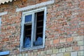 One old white window with broken glass on a red brick wall Royalty Free Stock Photo